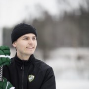 Valmentaja Konsta Kuusinen nojaa jääkiekkomailaan
