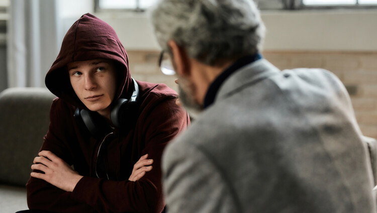 Teini-ikäinen poika psykoterapeutilla