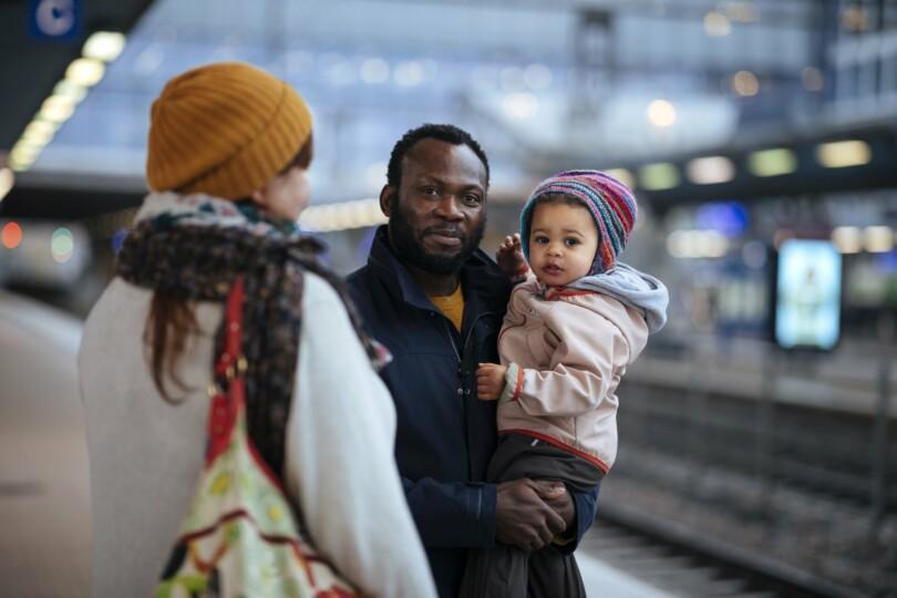 Isä pitää lasta sylissä.