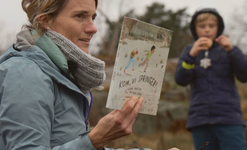 Kvinna visar fram en barnbok